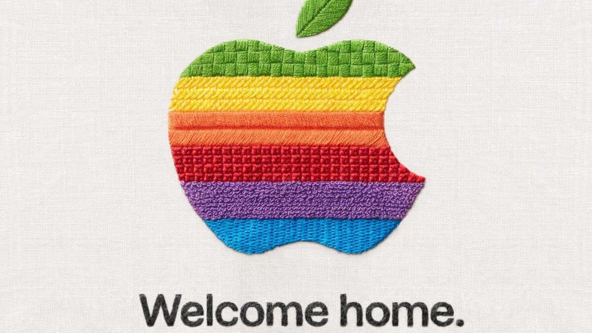 A graphic showing the Apple logo embroidered in rainbow colors above the words, "welcome home."